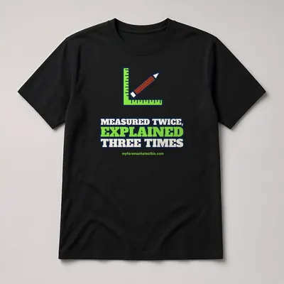 Mockup: Measured Twice, Explained Three Times on a black T-shirt